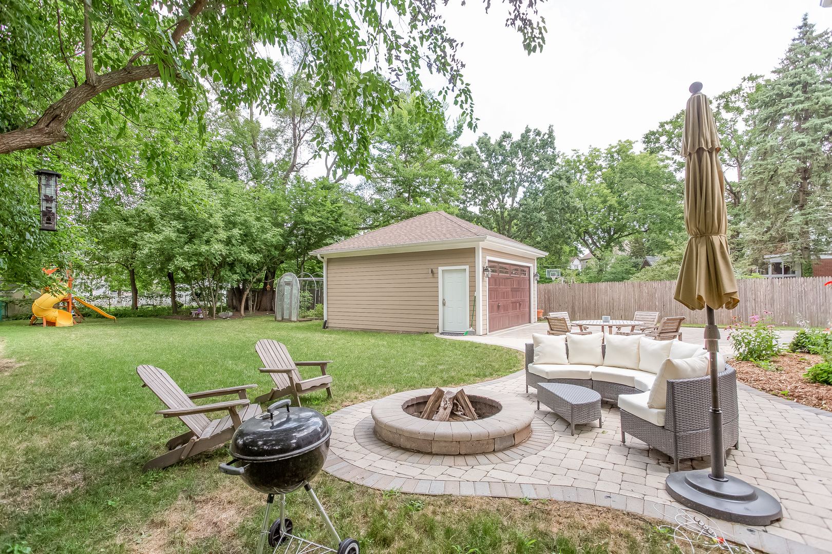 192 Riverside Road Riverside, IL 60546 - Photo 50 of 56 a view of a house with backyard sitting area and garden