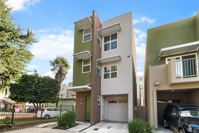 a front view of a building with a yard