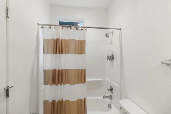 a bathroom with a shower and a toilet
