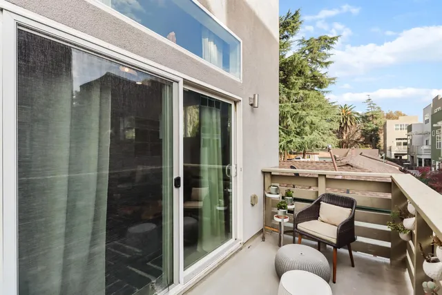 a kitchen with a sink a stove cabinets and wooden floor