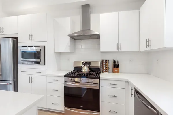 a kitchen with a sink cabinets and window