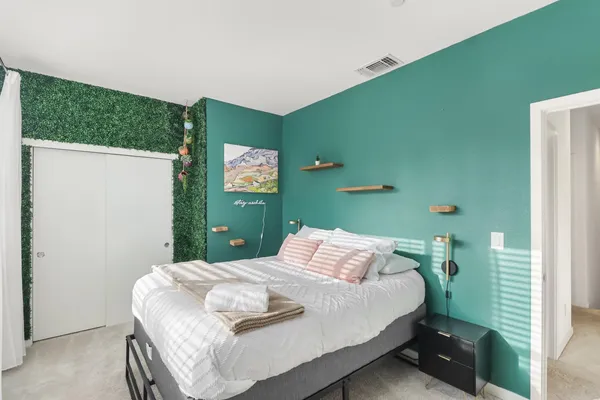 a bedroom with a bed and a window