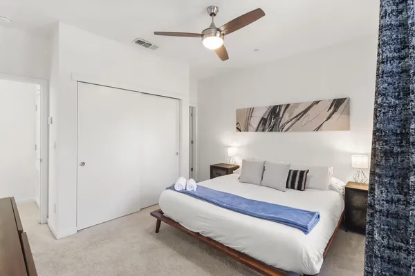 a bedroom with a large bed and a window