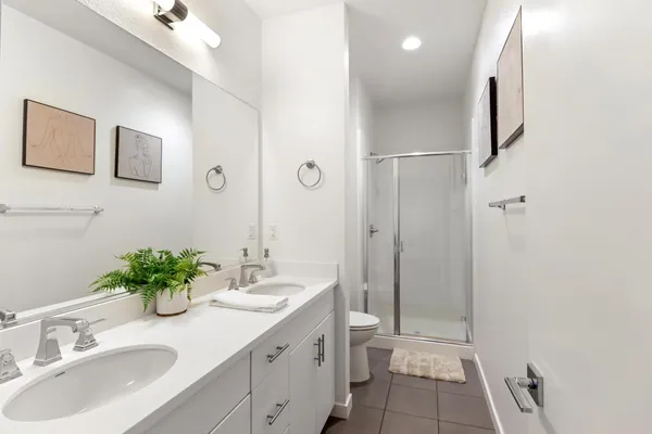 a en suite bathroom with double sink and a mirror