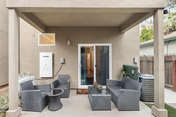 a view of a house with backyard porch and outdoor seating