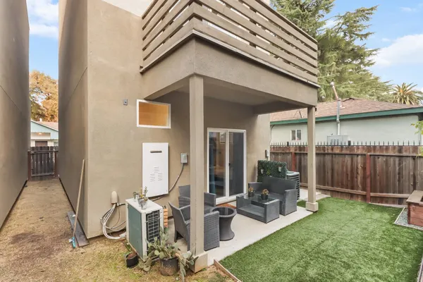 a backyard of a house with outdoor seating