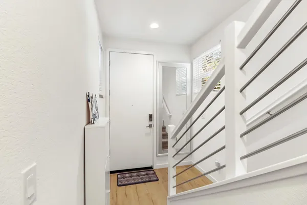 a view of staircase with white walls and a window
