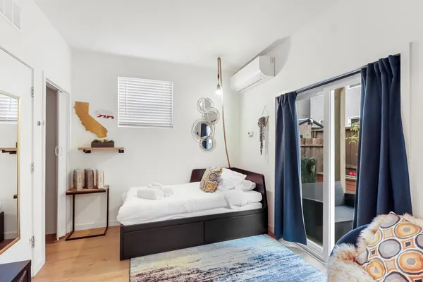 a bedroom with a bed and wooden floor