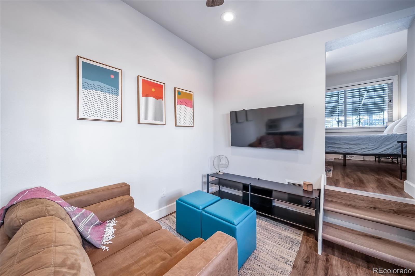 3536 North Williams Street, Unit 1 5 Denver, CO 80205 - Photo 4 of 15 a living room with furniture and a flat screen tv