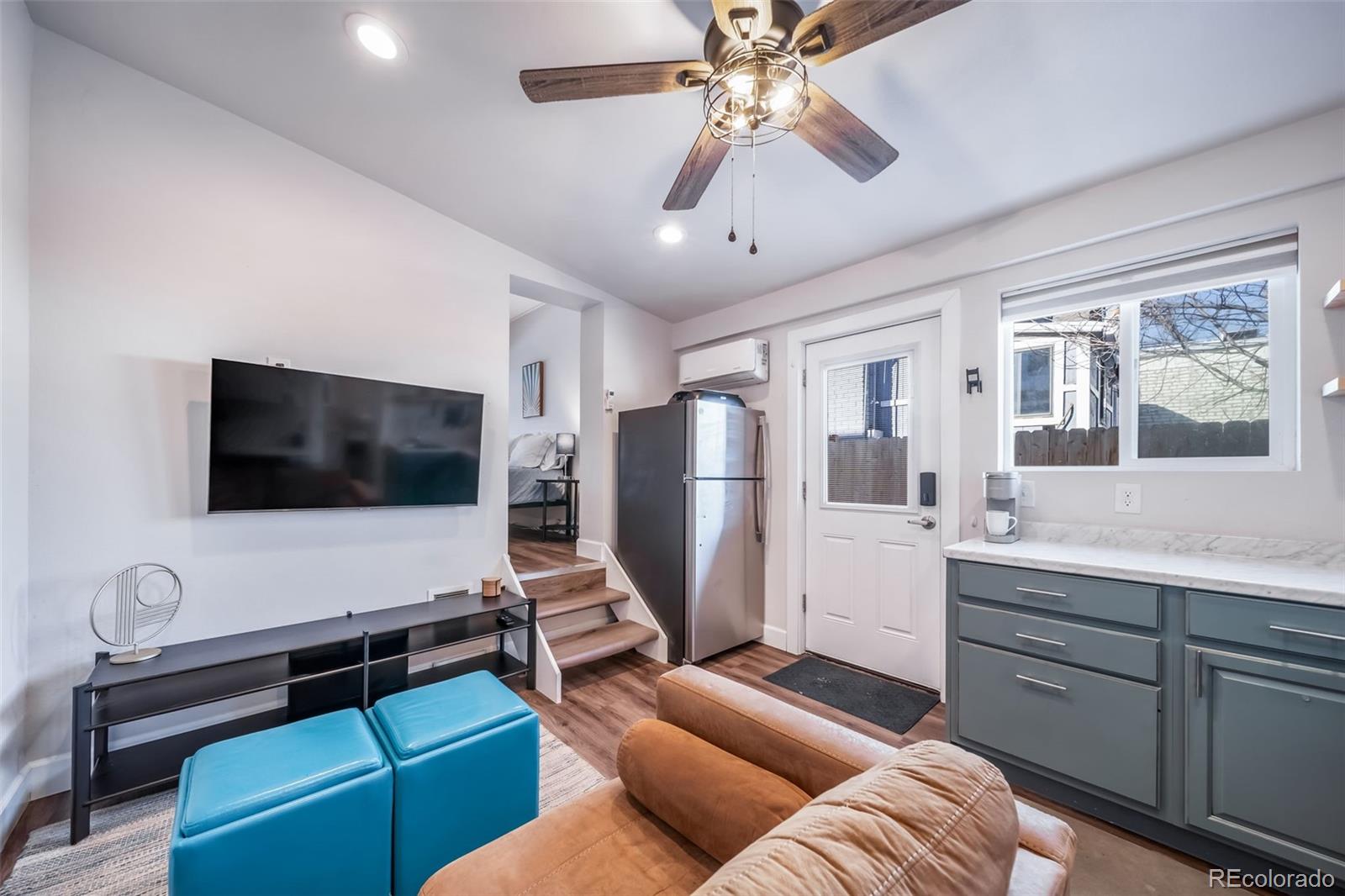 3536 North Williams Street, Unit 1 5 Denver, CO 80205 - Photo 5 of 15 a living room with furniture and a flat screen tv