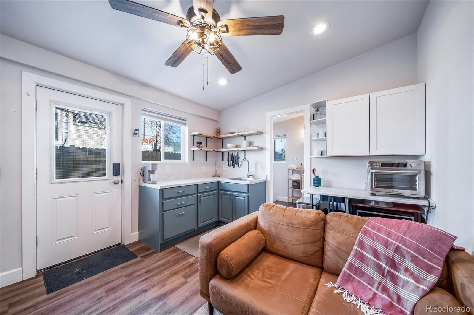 3536 North Williams Street, Unit 1 5 Denver, CO 80205 - Photo 6 of 15 a kitchen with stainless steel appliances granite countertop a refrigerator a sink dishwasher a stove and white cabinets with wooden floor