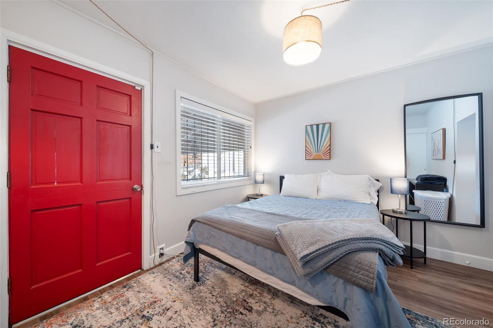 3536 North Williams Street, Unit 1 5 Denver, CO 80205 - Photo 10 of 15 a bedroom with a bed and dresser with mirror
