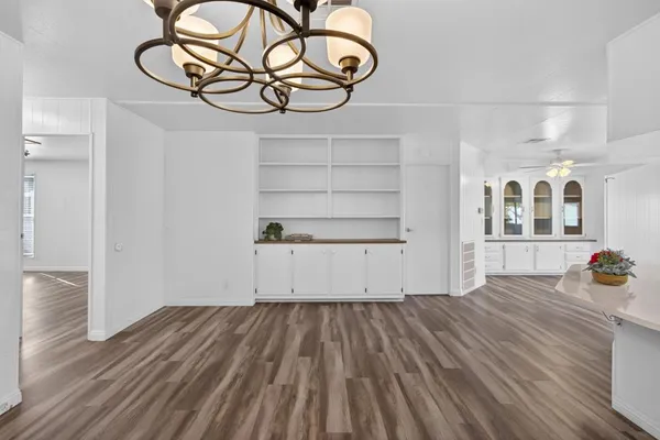 a view of a room with wooden floor and windows