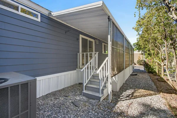 a view of a house with backyard and trees