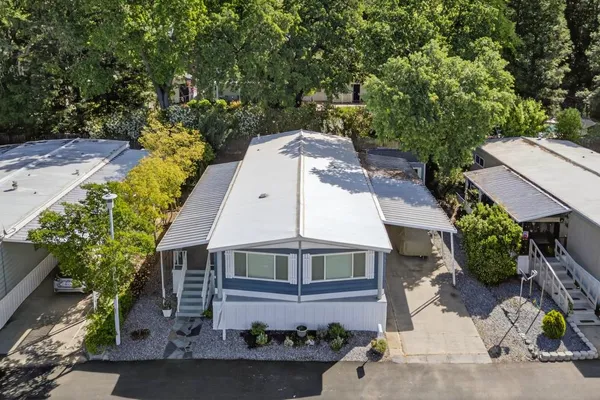 an aerial view of a house with a yard