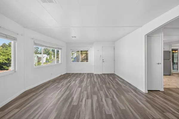 a view of a kitchen with wooden floor and a kitchen