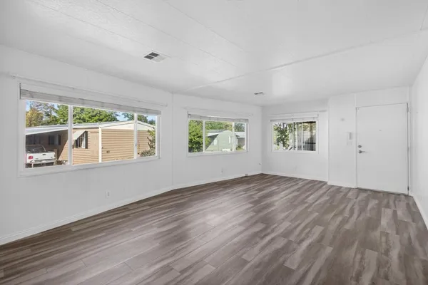 a kitchen with stainless steel appliances kitchen island granite countertop a refrigerator and a stove