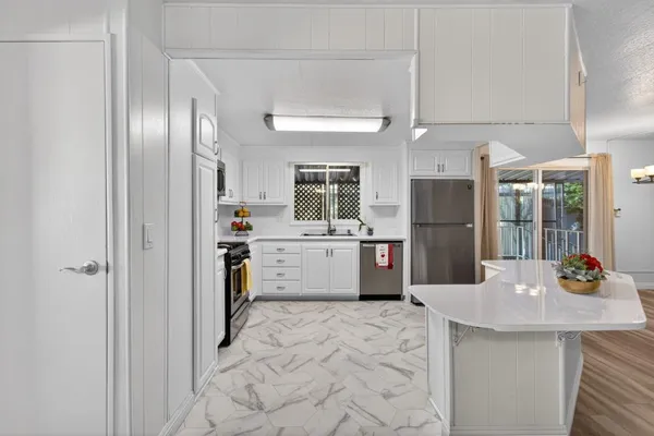 a view of a bedroom with wooden floor and a window