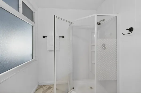 a bathroom with a sink vanity granite and a mirror