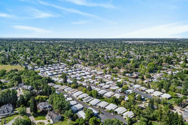 an aerial view of residential houses with outdoor space