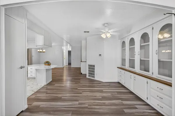 a view of a kitchen with an entryway and wooden floor