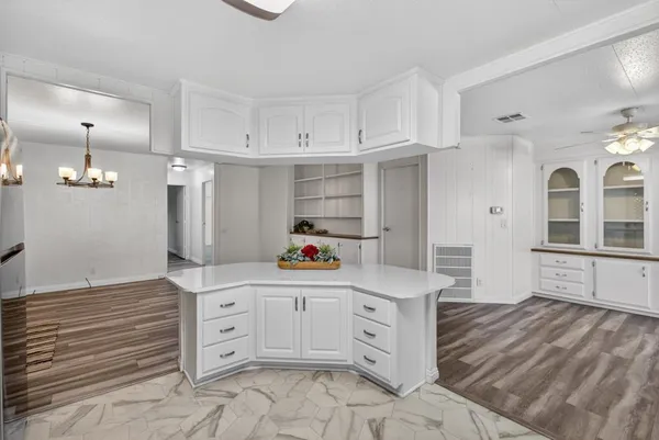 a kitchen view with granite countertop a stove a sink and a refrigerator