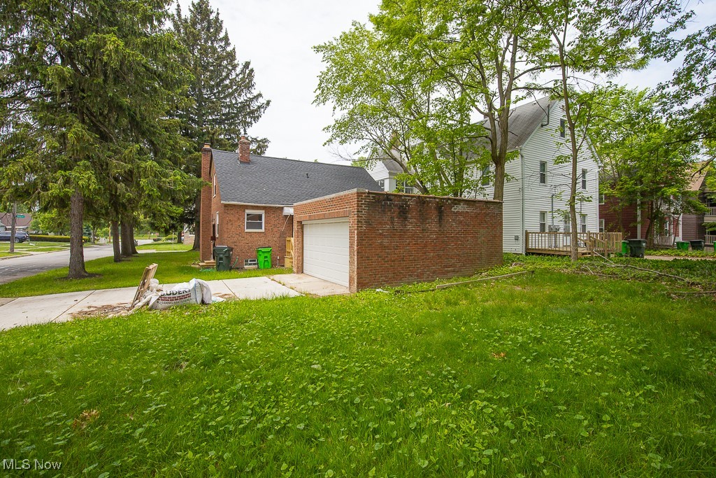 1547 Genesee Road South Euclid, OH 44121 - Photo 34 of 36 View of grassy yard with a garage and driveway