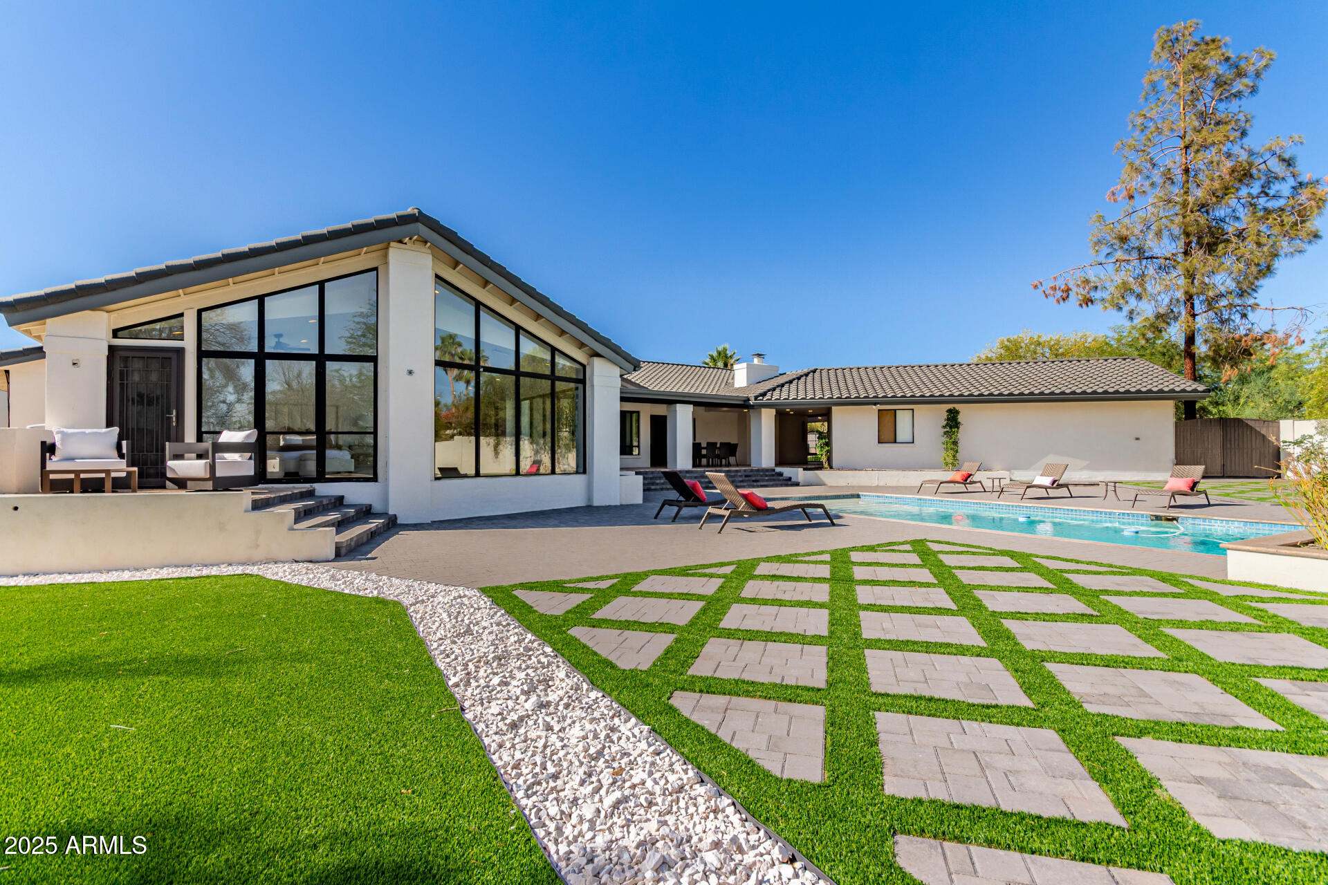3301 East Rovey Avenue Paradise Valley, AZ 85253 - Photo 99 of 105 a front view of a house with swimming pool having outdoor seating