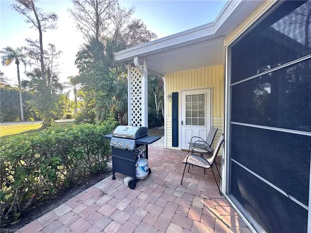 a view of a house with backyard sitting area and garden
