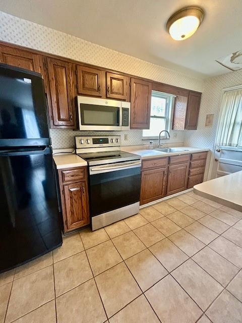 5384 Highgrove Road Pittsburgh, PA 15234 - Photo 4 of 13 Kitchen nas ceramic flooring and is equipped with electric stove, microwave and refrigerator.