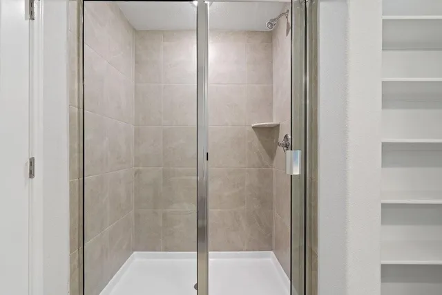 a bathroom with a glass shower door