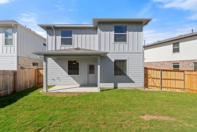 a view of a house with wooden fence