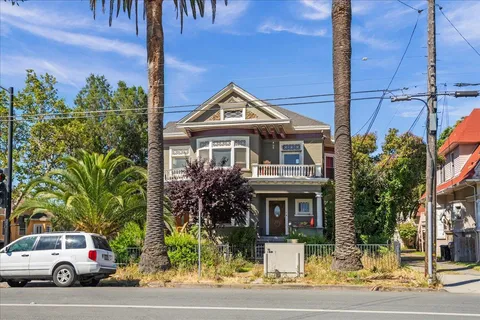 a front view of a house with a garden and plants