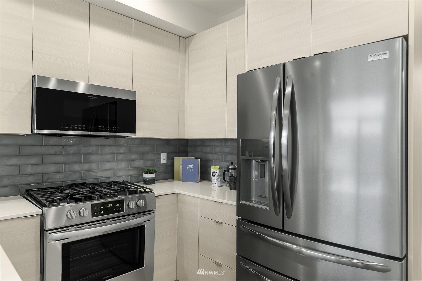 4125 Wallingford Avenue North Seattle, WA 98103 - Photo 11 of 28 a kitchen with stainless steel appliances a refrigerator stove and microwave