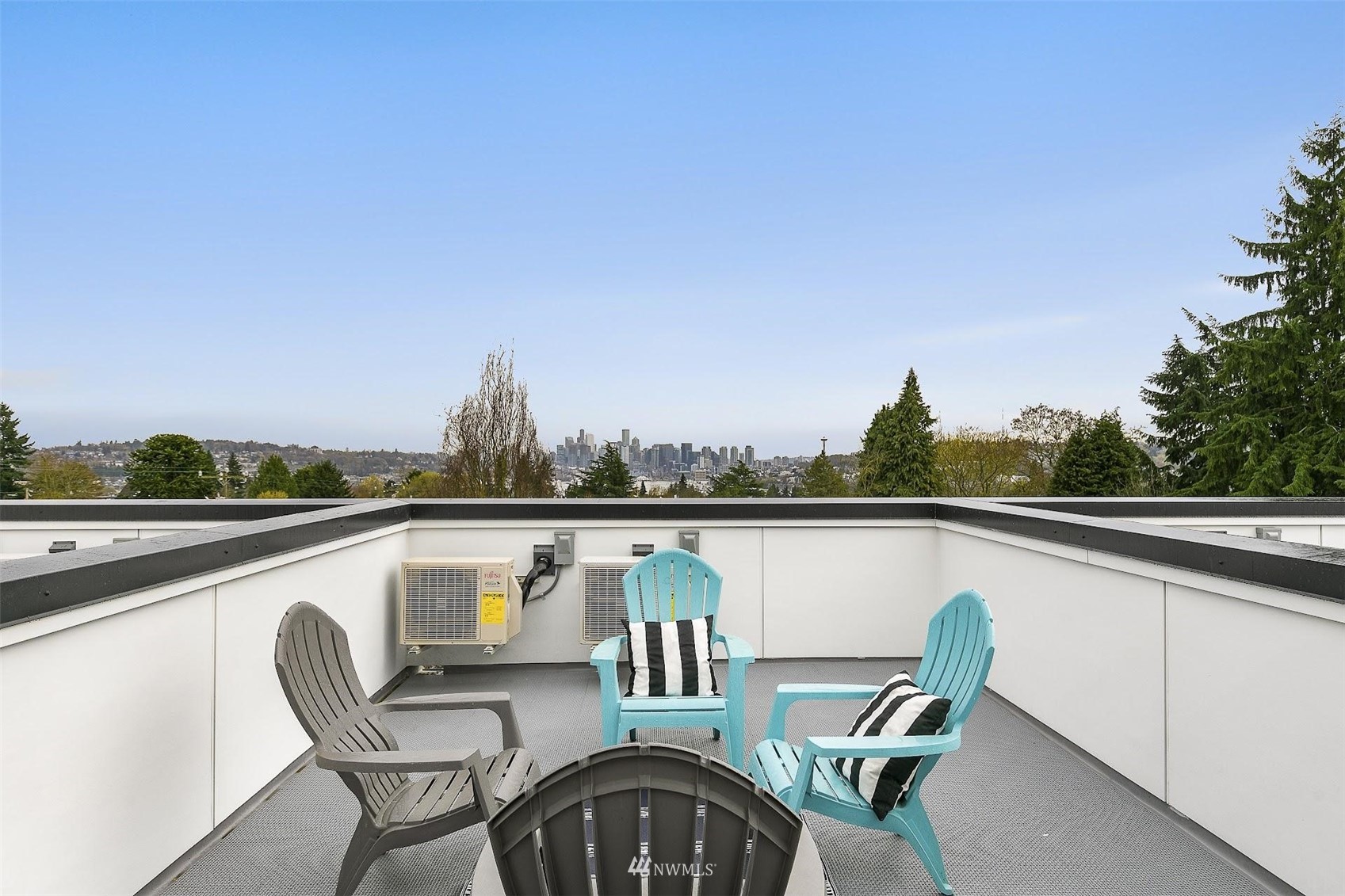 4125 Wallingford Avenue North Seattle, WA 98103 - Photo 23 of 28 a view of a balcony with table and chairs and wooden floor
