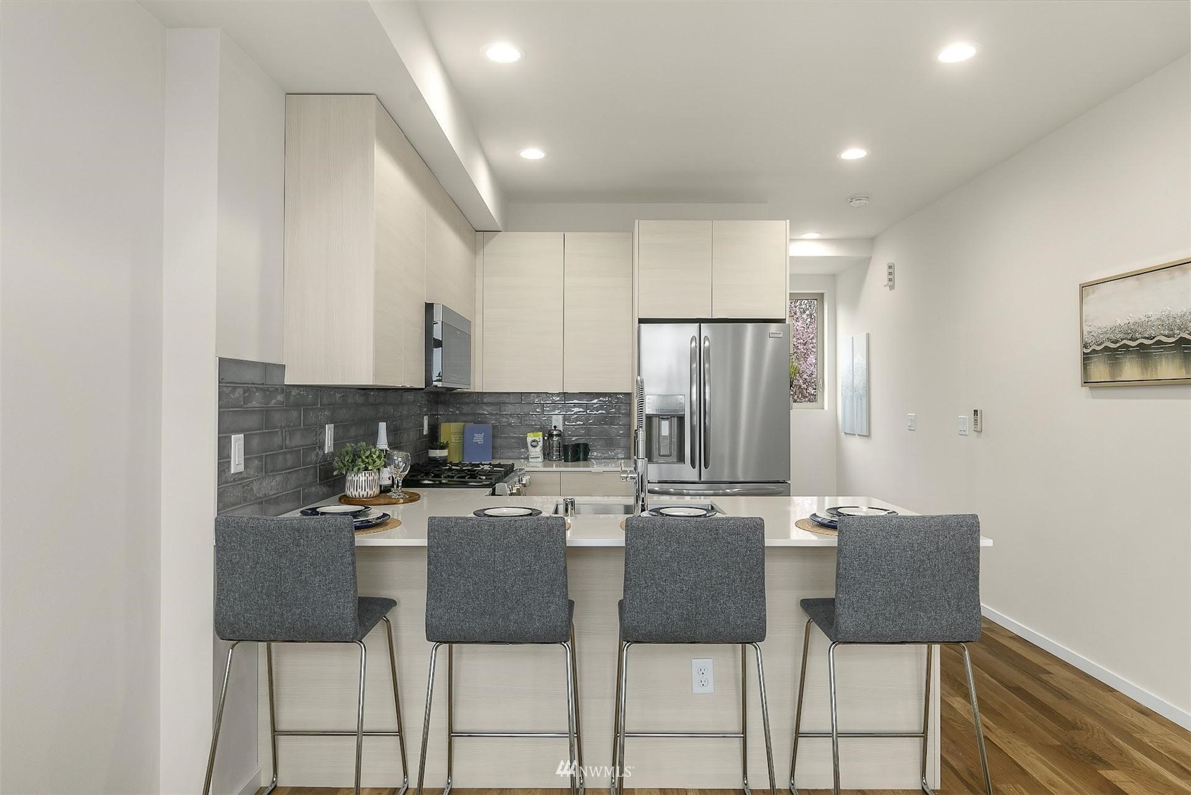 4125 Wallingford Avenue North Seattle, WA 98103 - Photo 9 of 28 a kitchen with a dining table chairs and refrigerator
