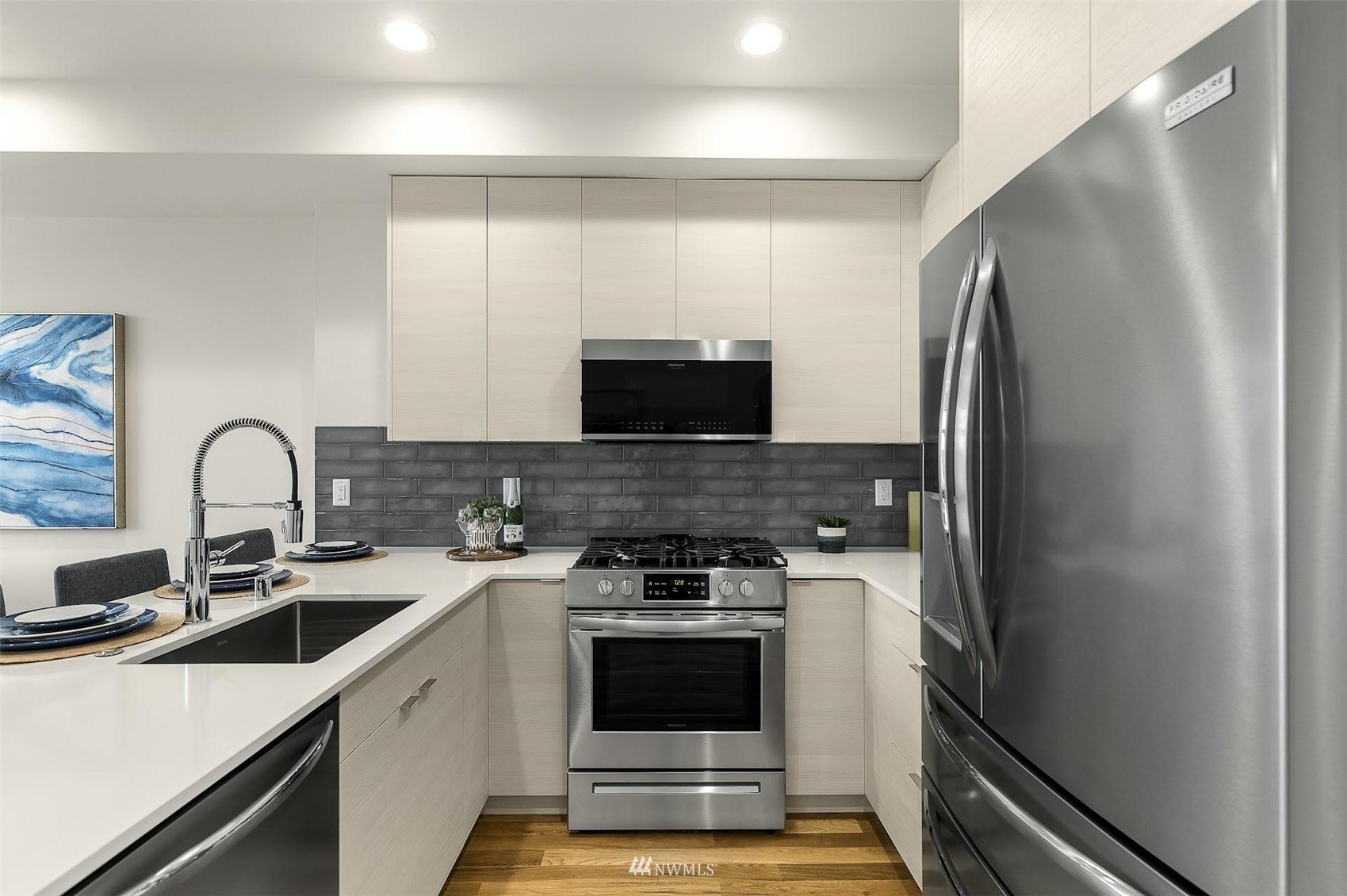 4125 Wallingford Avenue North Seattle, WA 98103 - Photo 10 of 28 a kitchen with stainless steel appliances a stove microwave and a sink