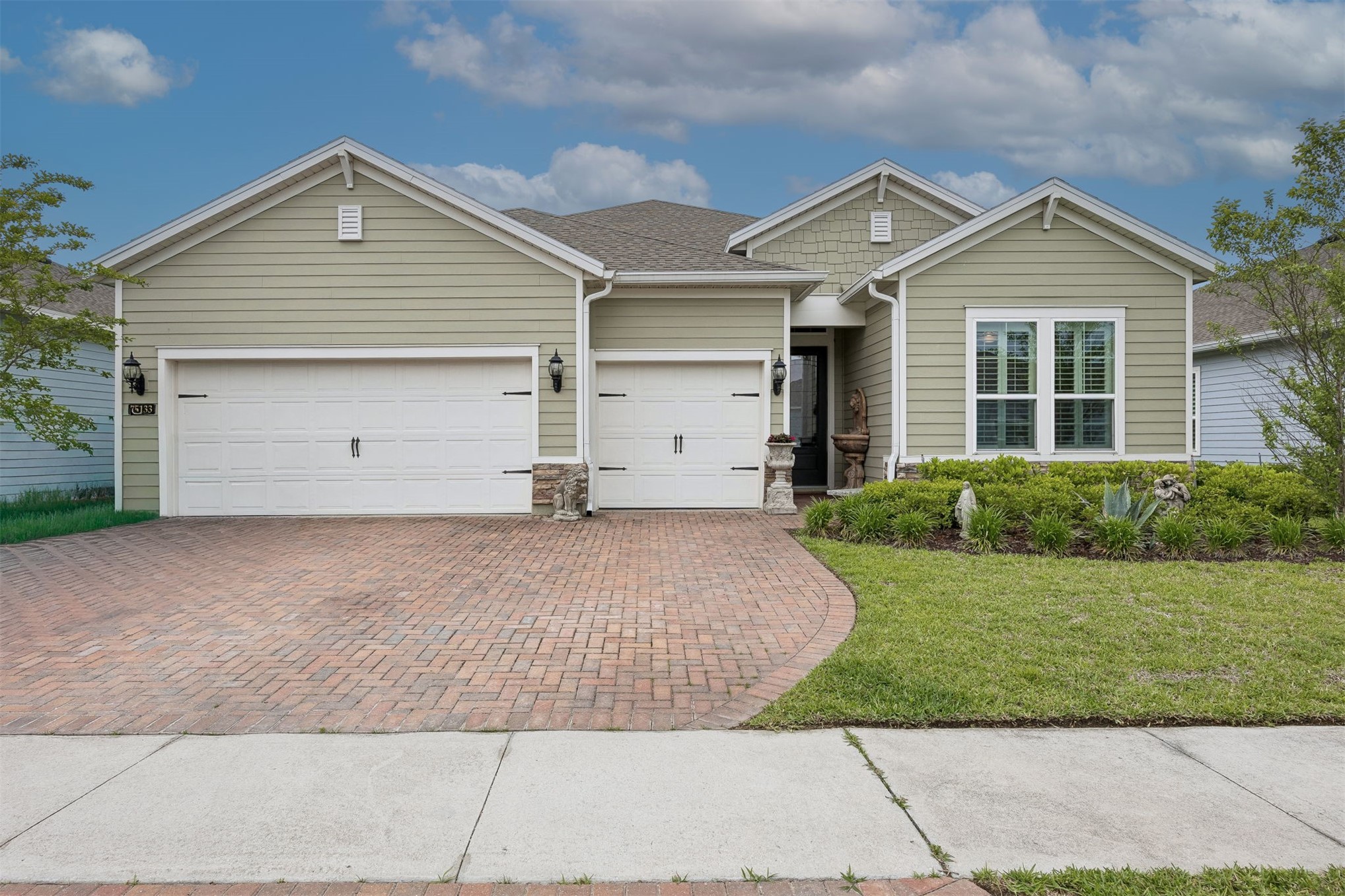 75133 Pondside Lane Yulee, FL 32097 - Photo 2 of 65 a front view of a house with a yard and garage