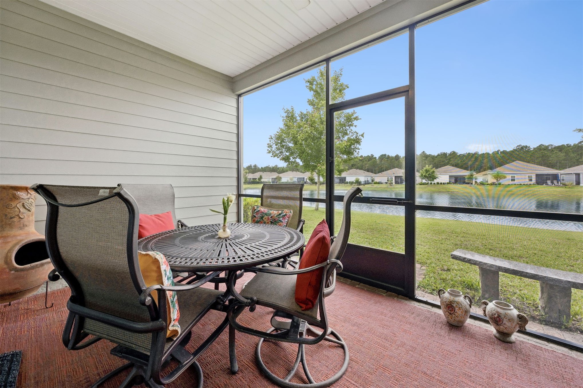 75133 Pondside Lane Yulee, FL 32097 - Photo 32 of 65 a dining room with furniture and a floor to ceiling window