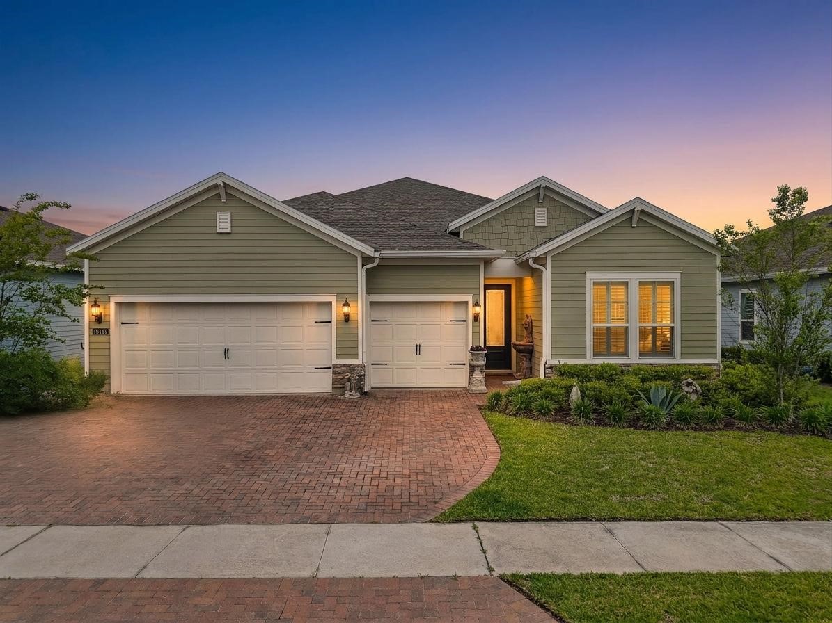 75133 Pondside Lane Yulee, FL 32097 - Photo 46 of 65 a front view of a house with a yard and garage