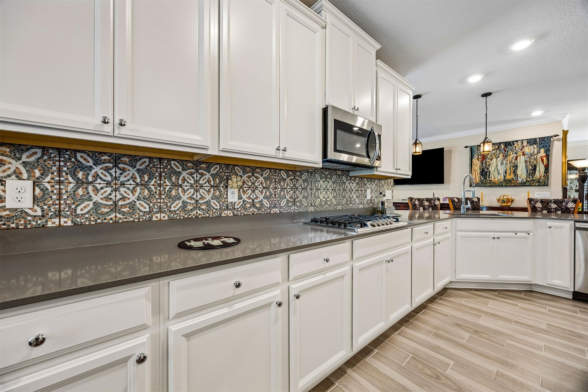 75133 Pondside Lane Yulee, FL 32097 - Photo 8 of 65 a kitchen with granite countertop cabinets stainless steel appliances a sink and wooden floor
