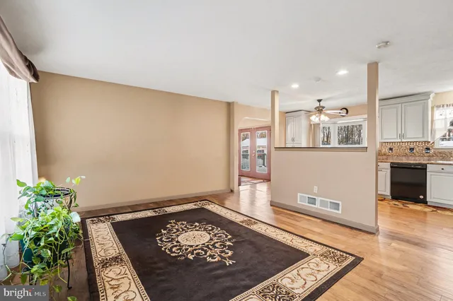 a view of a room with wooden floor and plant