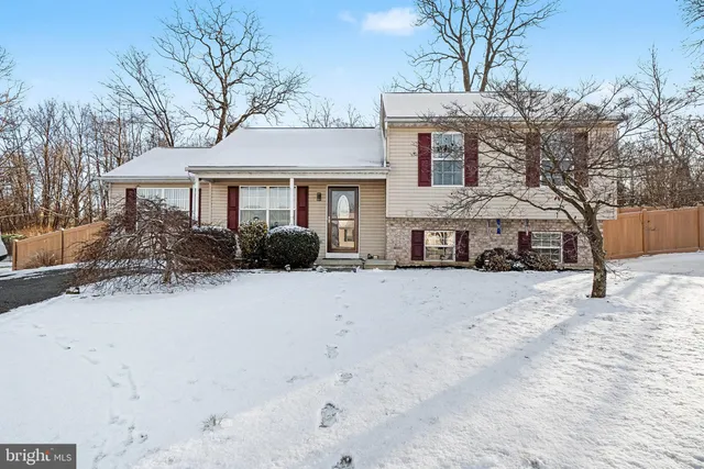 a front view of a house with yard covered in snow