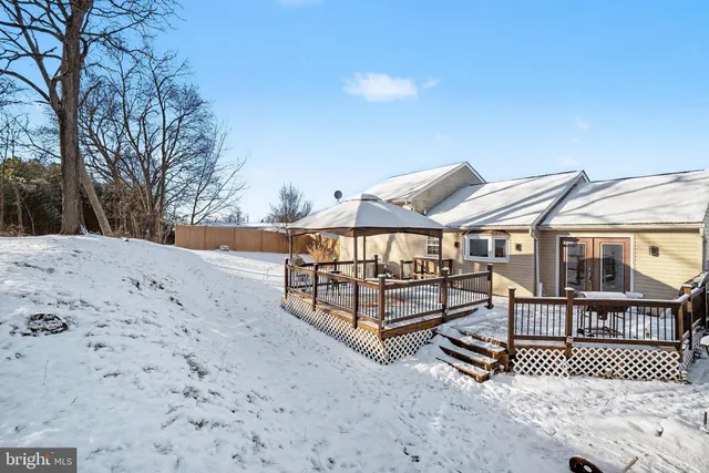 a view of a roof deck with wooden fence and wooden fence