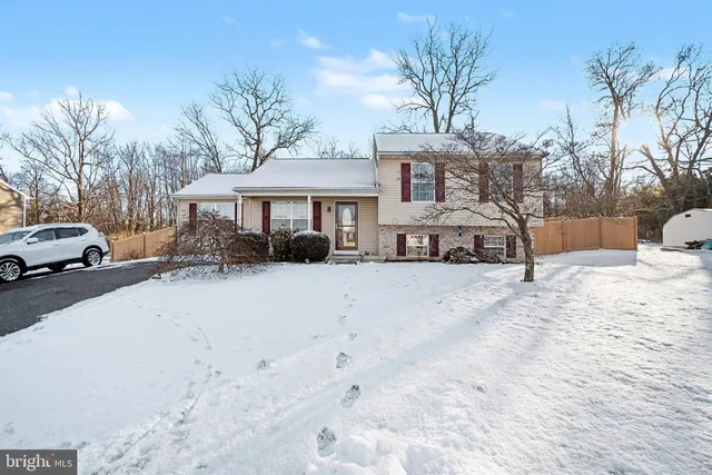 a view of a house with a snow in the yard