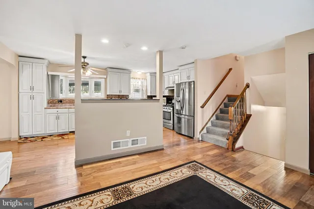 a view of a kitchen with wooden floor and electronic appliances