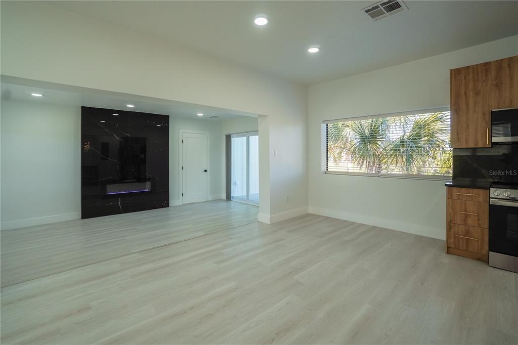 6821 Marius Road North Port, FL 34287 - Photo 12 of 39 an empty room with windows and fireplace