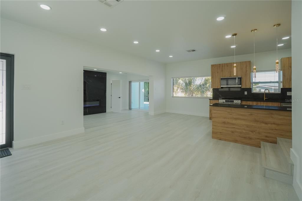 6821 Marius Road North Port, FL 34287 - Photo 21 of 39 a large kitchen with stainless steel appliances a large counter top a stove and a refrigerator
