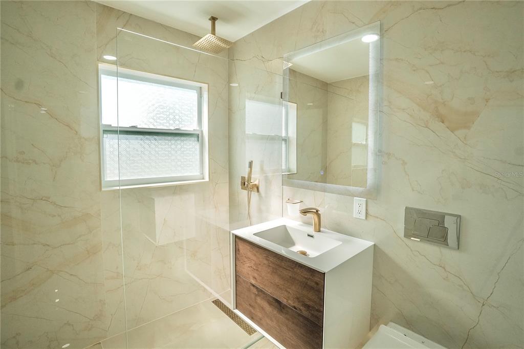 6821 Marius Road North Port, FL 34287 - Photo 25 of 39 a bathroom with a sink toilet and mirror