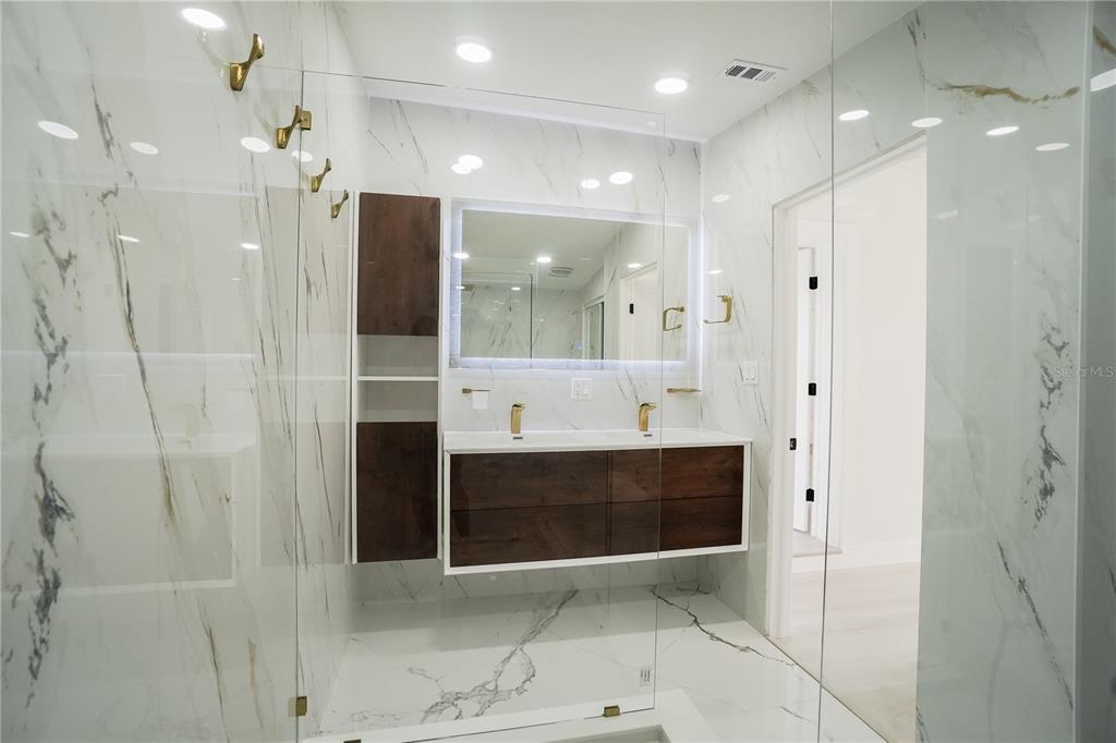 6821 Marius Road North Port, FL 34287 - Photo 31 of 39 a bathroom with a glass shower door and a sink